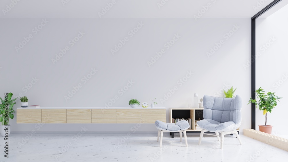 Tv cabinet and gray chair on concrete wall with marble flooring.