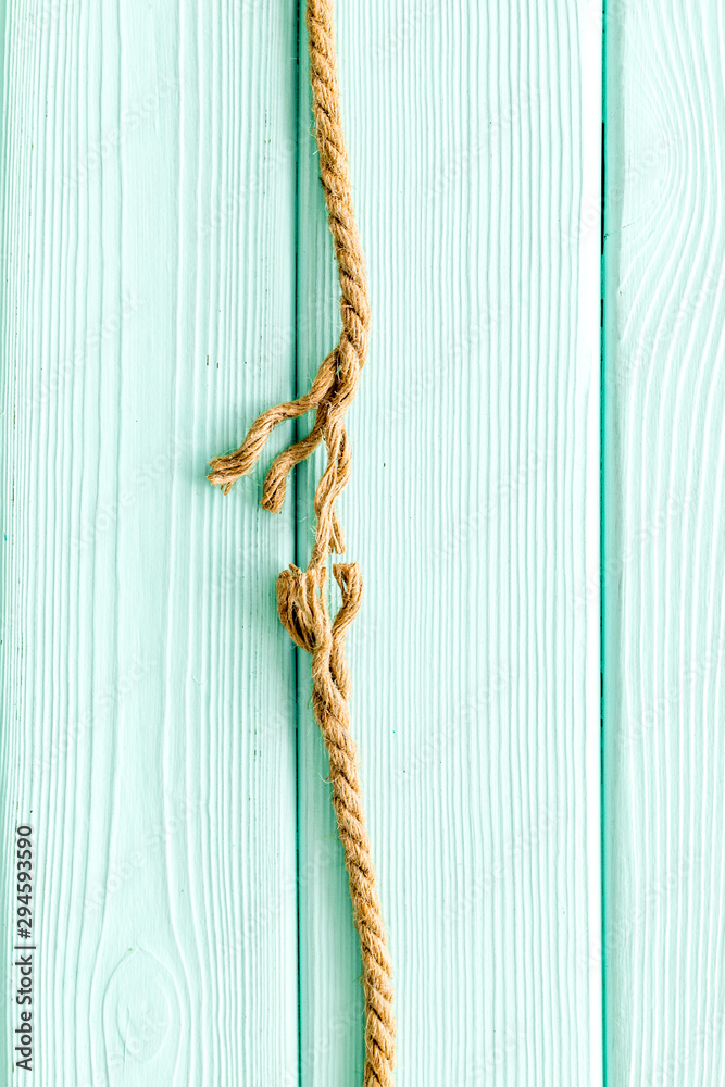 stress concept with breaking rope on mint green wooden background top view mockup