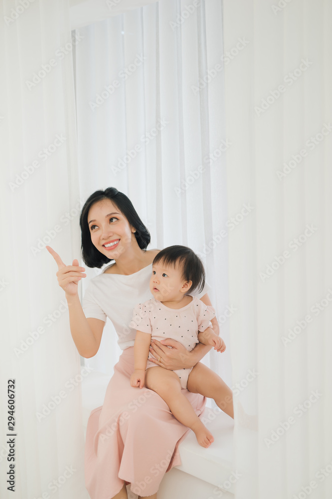 Mom and her daughter child girl are playing, smiling and hugging. Family holiday and togetherness.