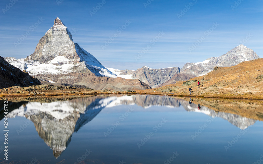 Reflection of Matterhorn peak over Riffelsee in Zermatt, Switzerland in autumn season, sunny day in 