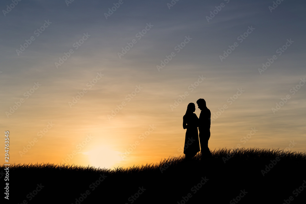 Silhouettes of couple man and woman in nature sunset background. Love concept.