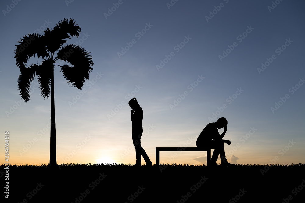 Silhouettes of couple man and woman broken heart at nature sunset. Love concept.