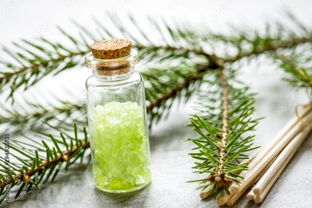 fir branches and spruce bath salt on white table background