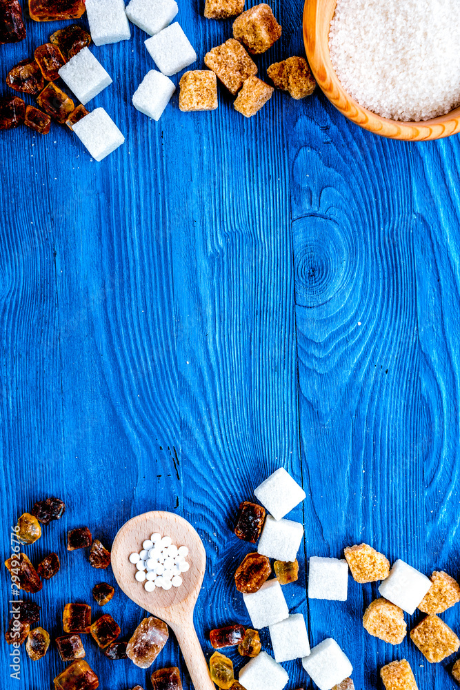 lumps of sugar with bowls sweet set on blue table background top view mockup