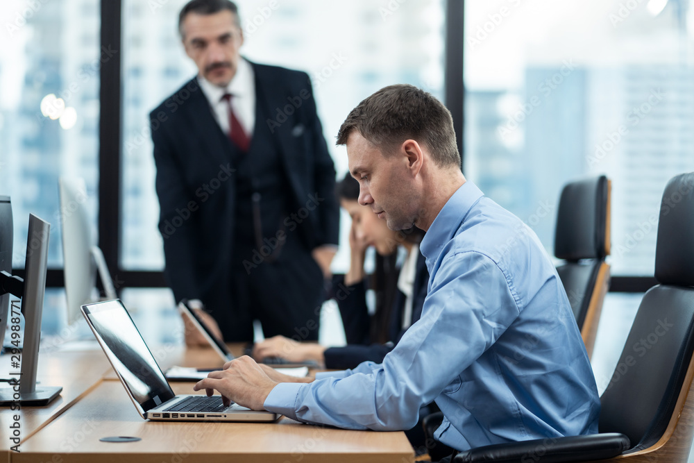 Group of diversity people working in office, two caucasian man and asian woman sitting on desk typin