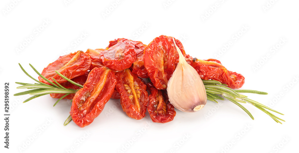 Dried tomatoes and spices on white background