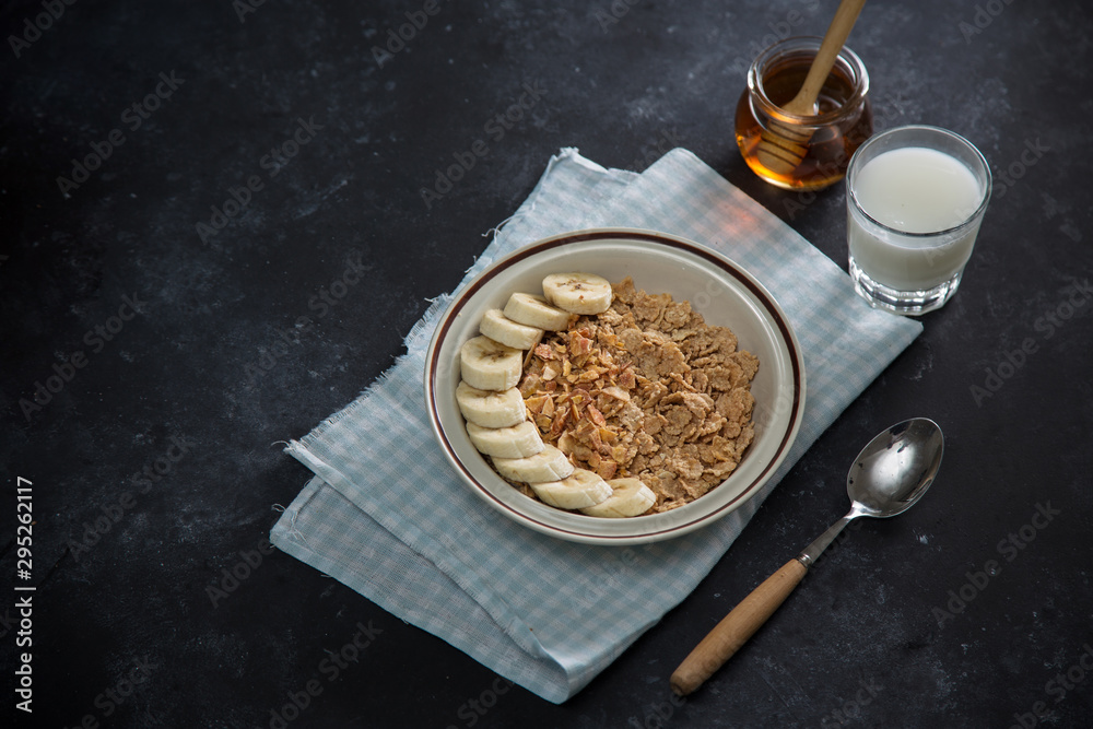 Tasty and healthy breakfast: fruits, corn flakes, milk and honey.