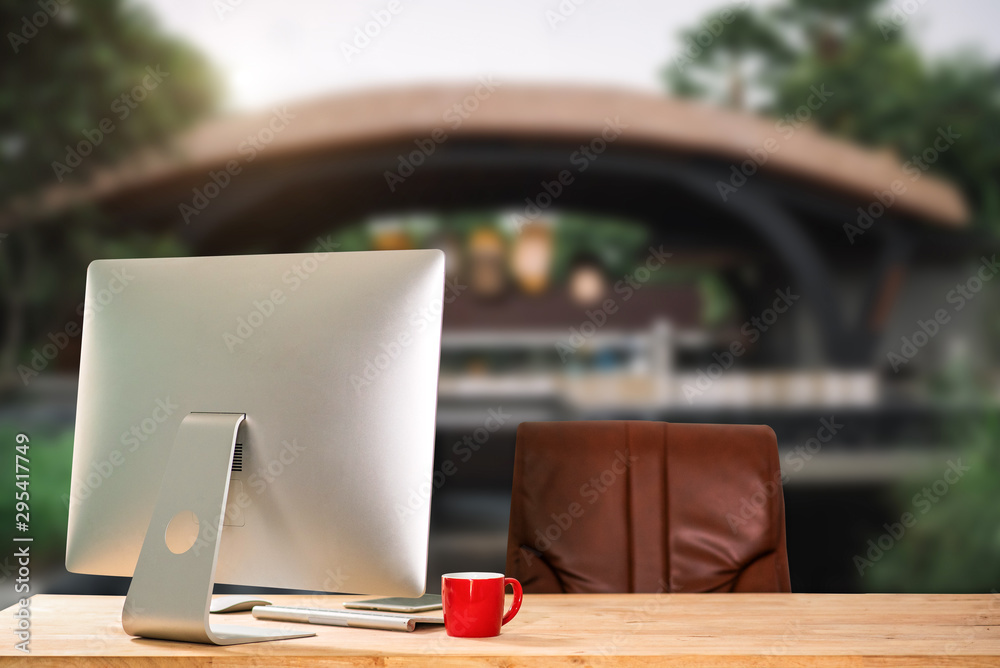 workspace with computer, laptop, office supplies, and coffee cup, smartphone, and tablet at office. 