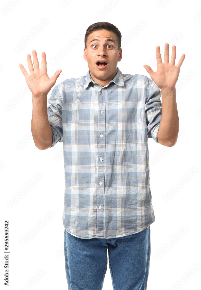 Portrait of shocked young man on white background