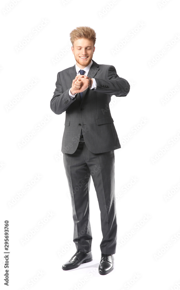 Portrait of handsome businessman looking a his watch on white background