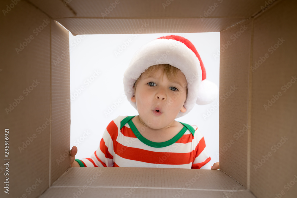 Surprised child unpack Christmas gift box