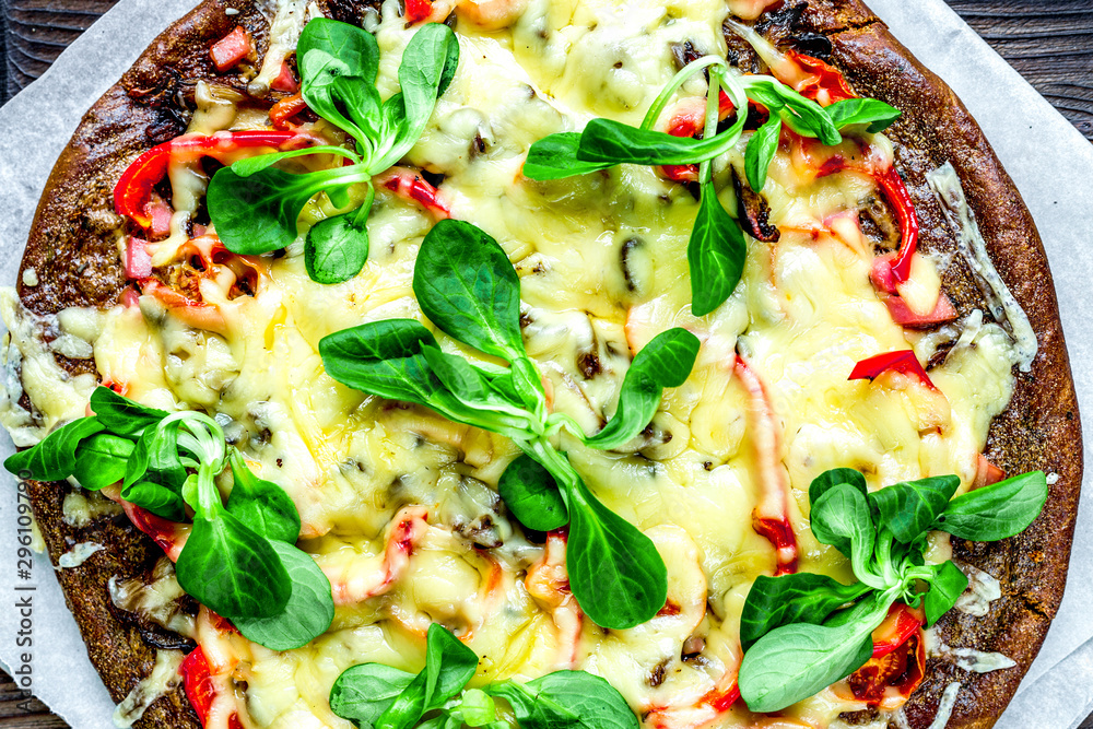 vegetarian pizza on wooden table background top view