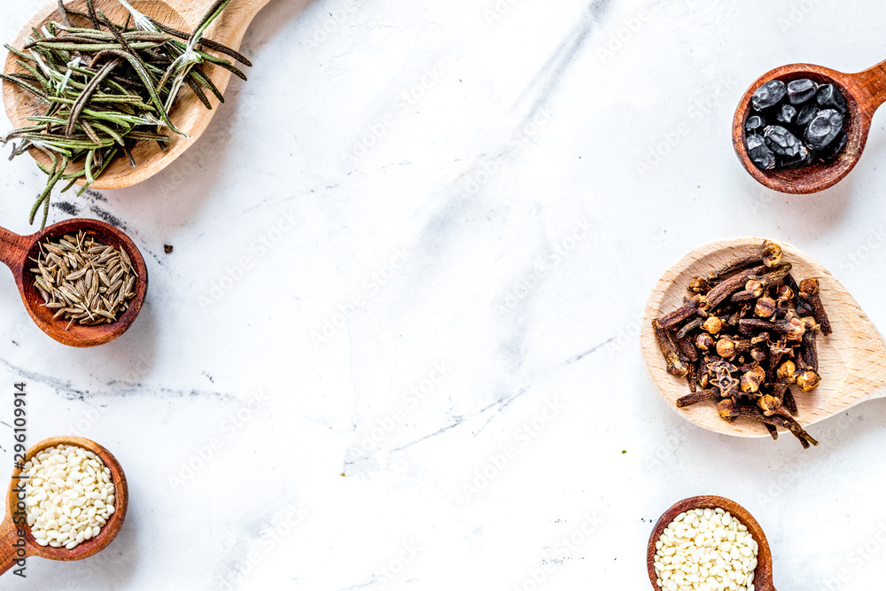 Flat lay vanilla, cinnamon, herb and spices on white kitchen background space for text