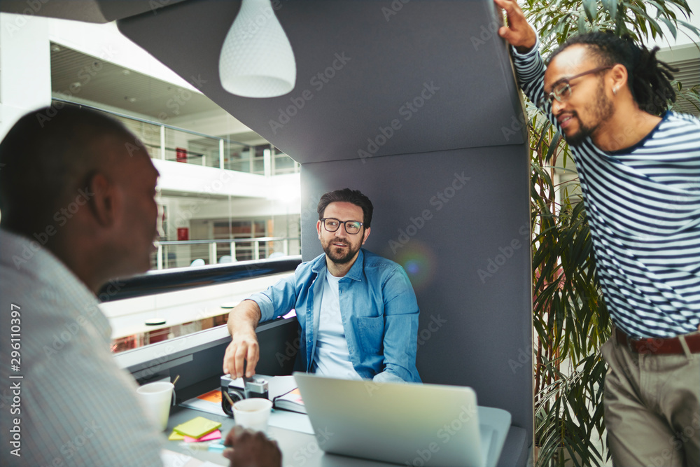 Diverse designers discussing work together in an office meeting