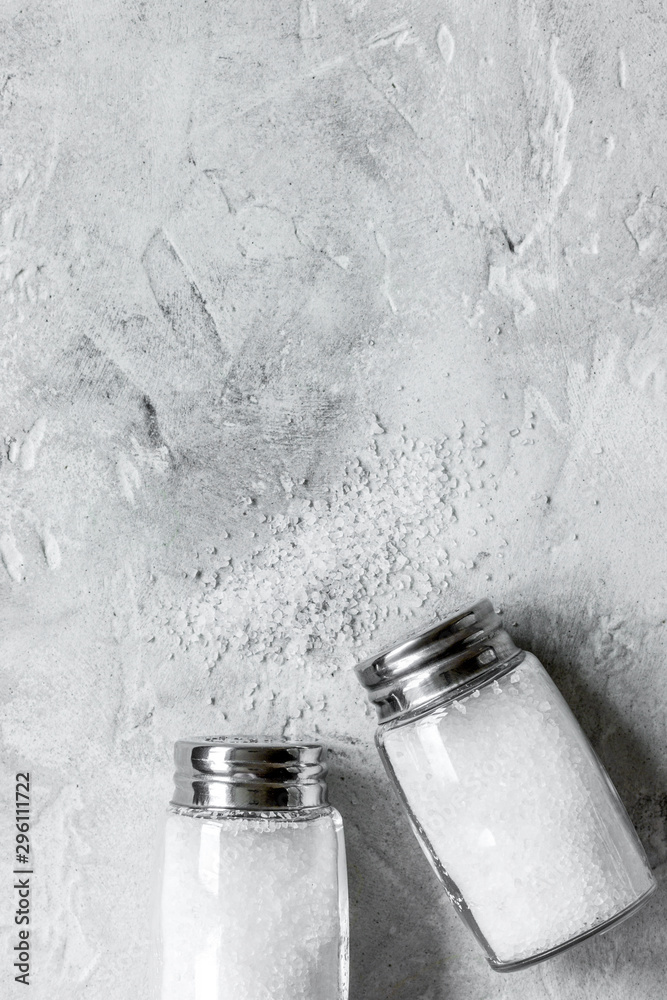 salt in glass bottle on gray table background top view space for text