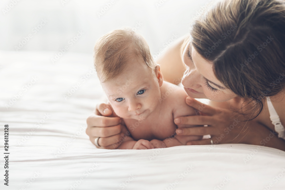 Loving mom carying of her newborn baby at home