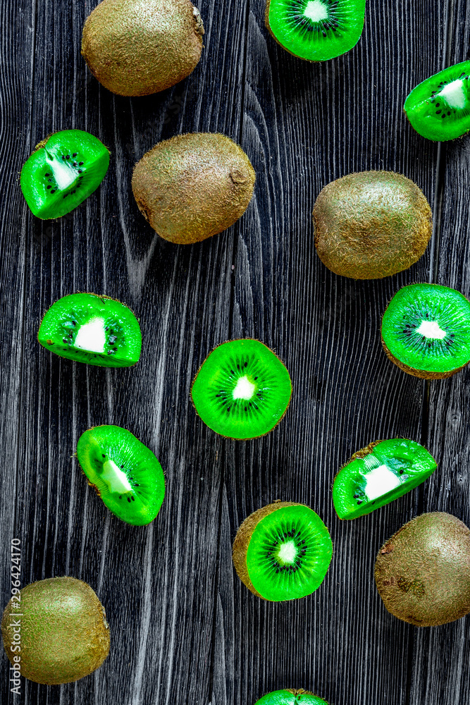 fresh green fruits with kiwi on wooden background top view pattern