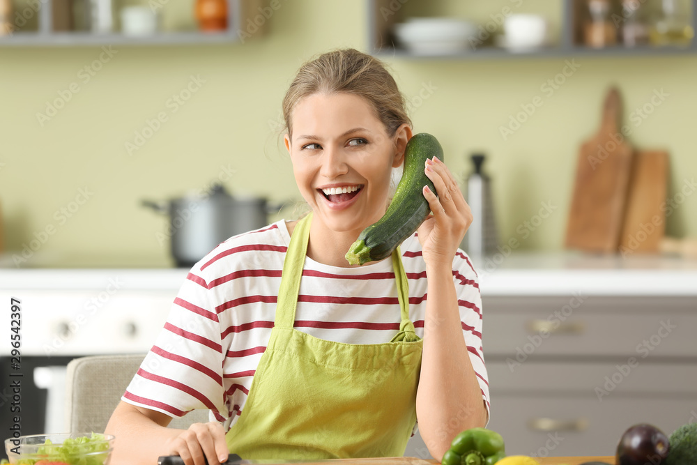 Beautiful young woman cooking in kitchen