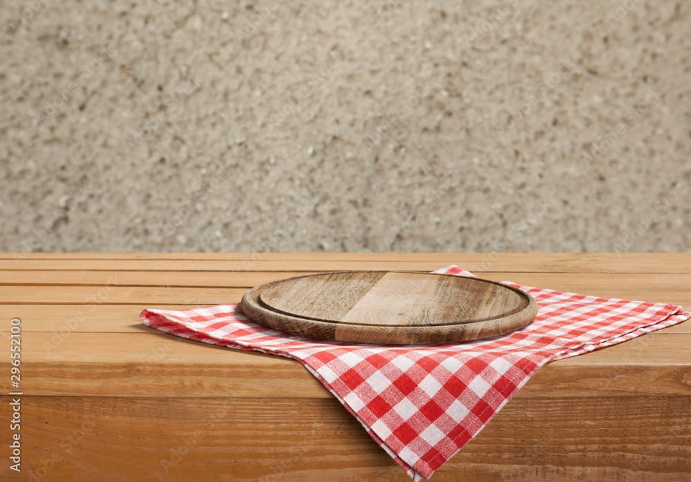 Cutting board and sackcloth on wooden table, copy space