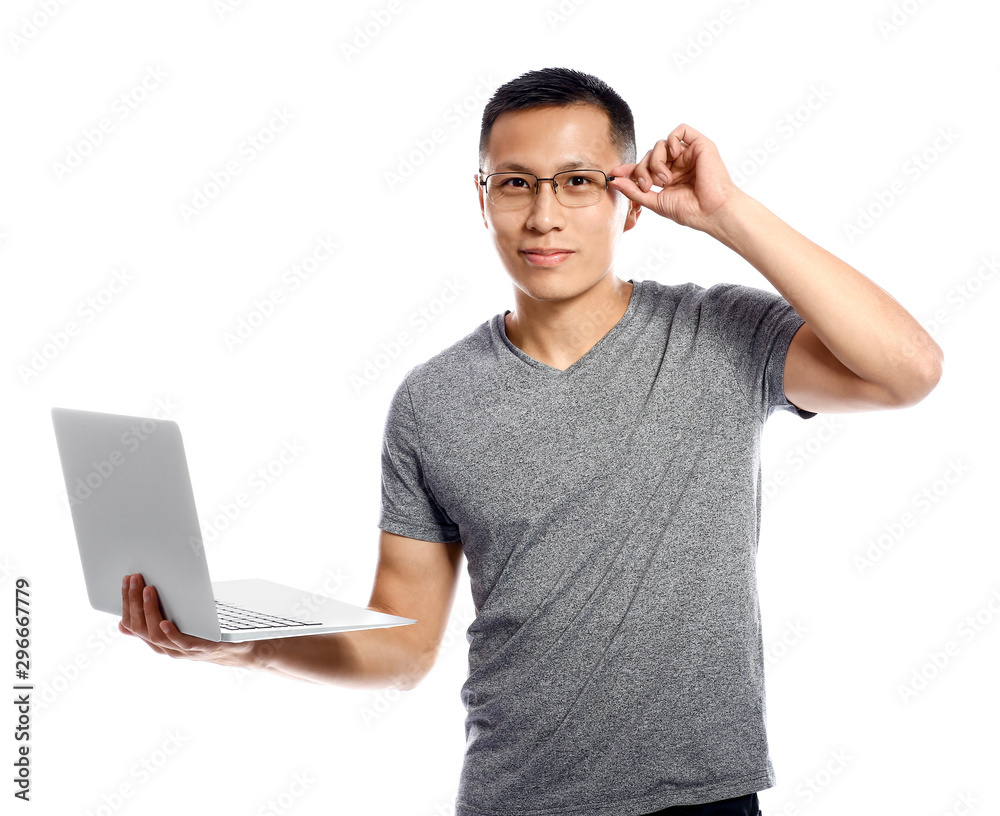 Male Asian programmer with laptop on white background