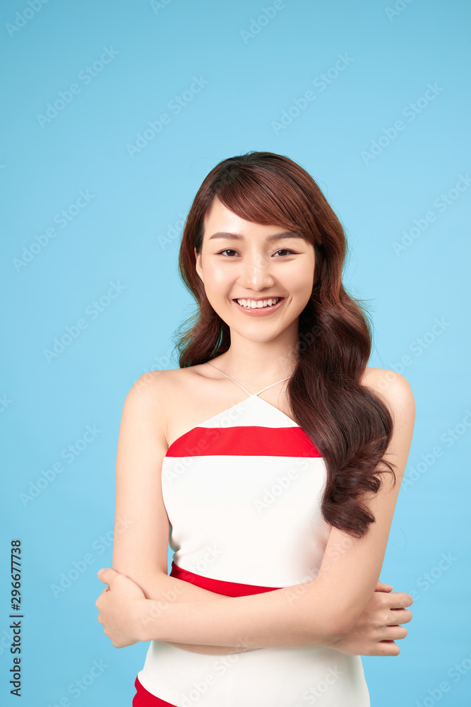 Asian woman smiling with casual clothing, blue background