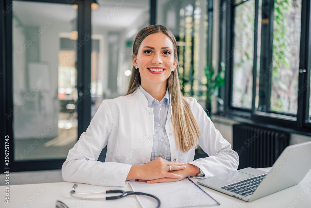 Portrait of a cheerful female doctor in medical office.