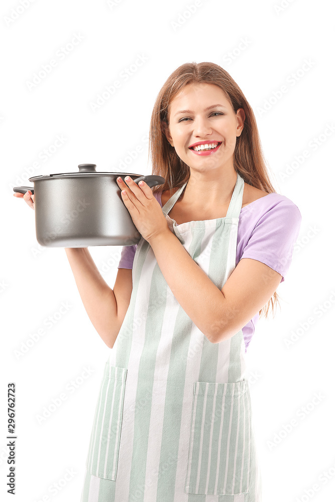 Beautiful young woman in apron and with saucepan on white background