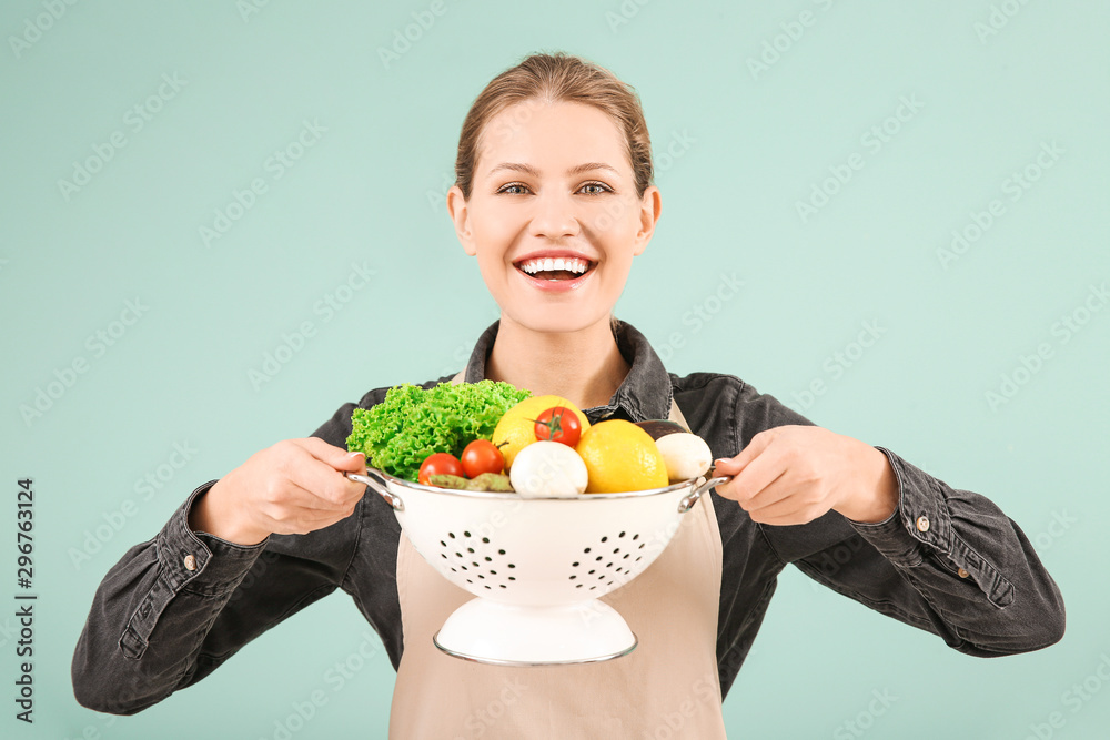 Beautiful young woman with products on color background