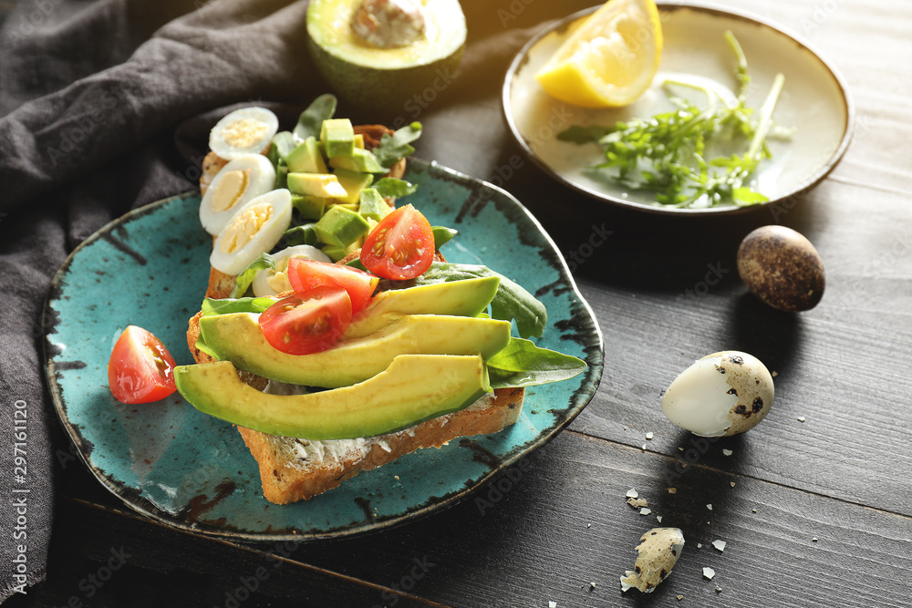 Plate with tasty sandwiches on table