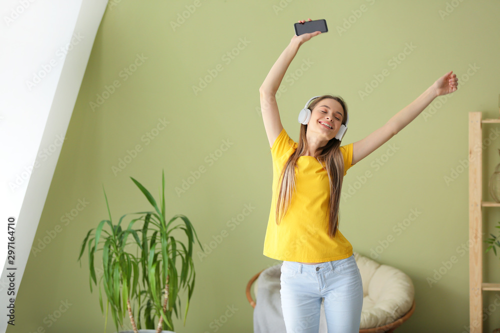 Dancing woman listening to music at home