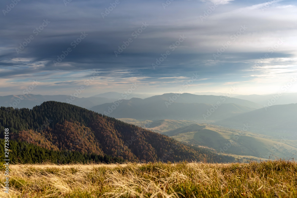 Beautiful sunset and layered mountain silhouettes in evening