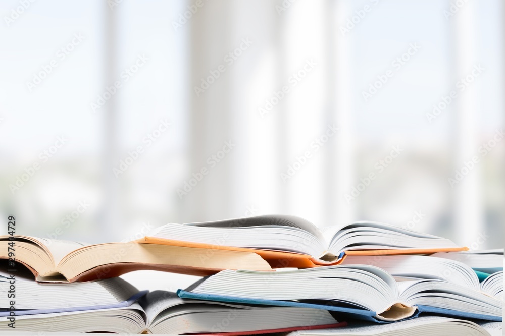 Colorful books collection on background.