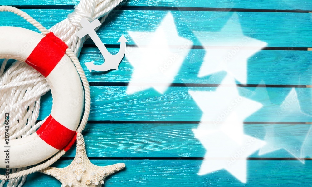 Decorative Lifebuoy and anchor on blue wooden planks background