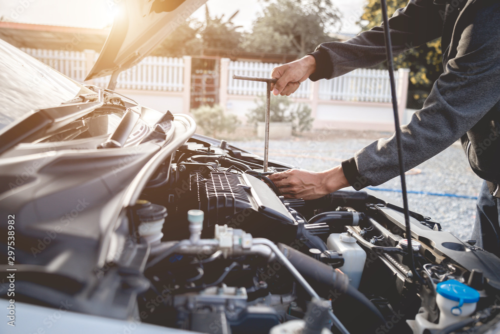 Technician working on checking and service car auto mechanic working in garage. Repair service.