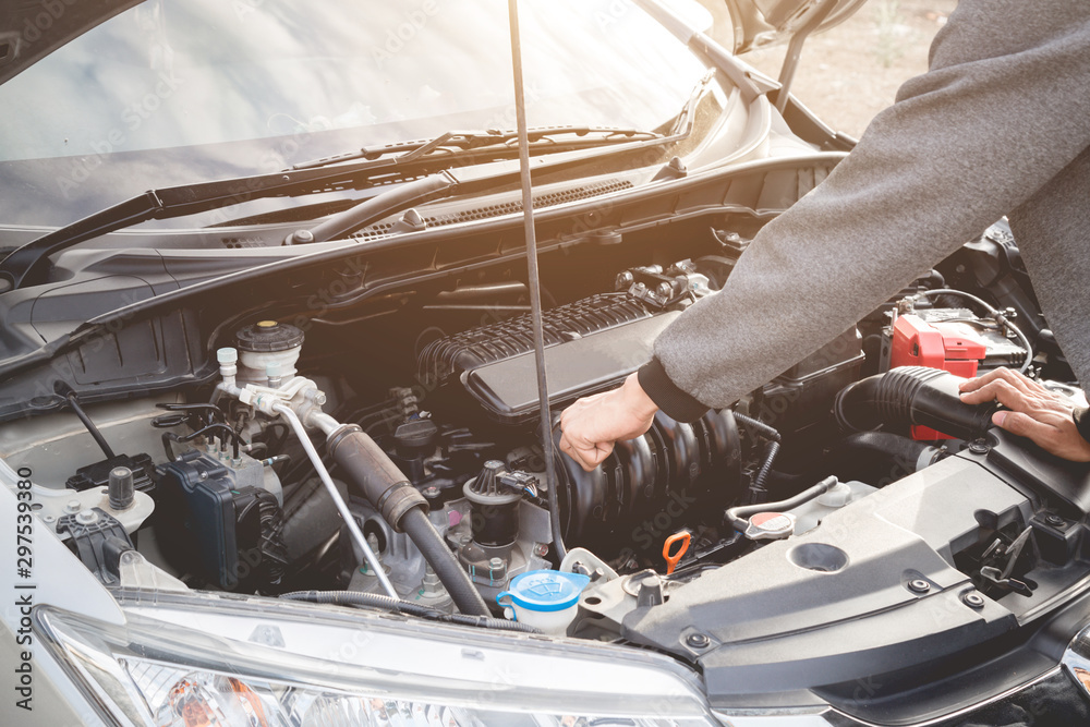 Technician working on checking and service car auto mechanic working in garage. Repair service.