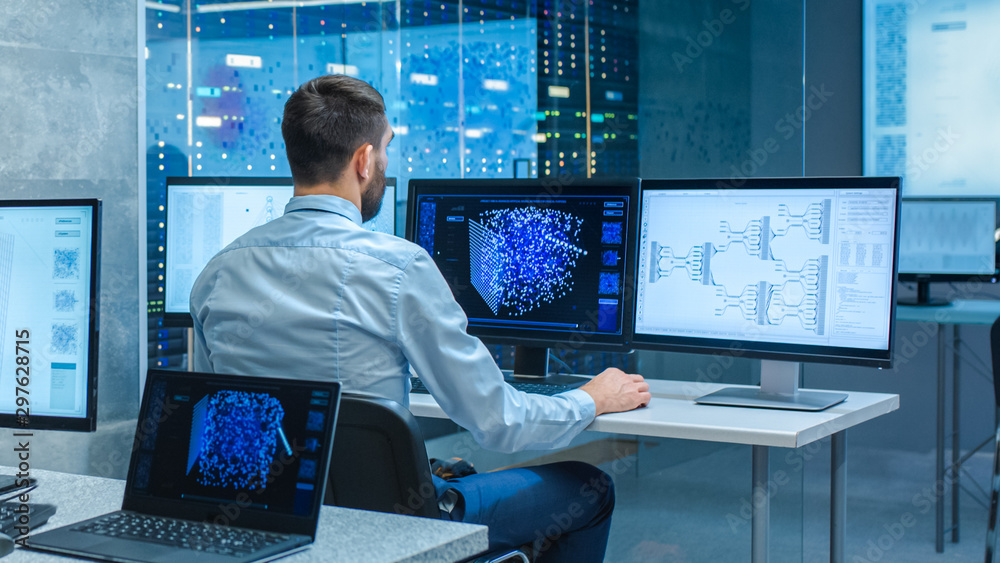 Beautiful Male Computer Engineer and Scientists Create Neural Network at His Workstation. Office is 