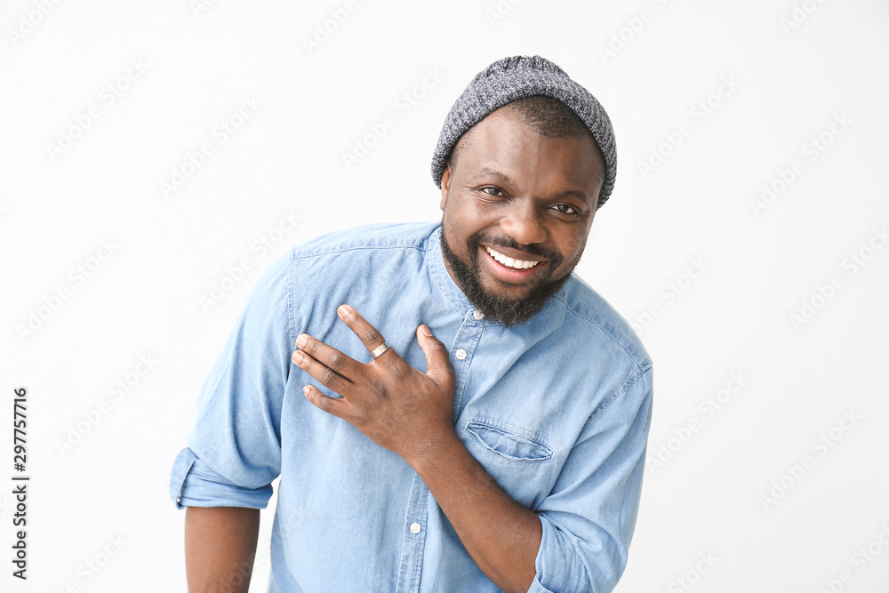 Portrait of happy African-American man on white background