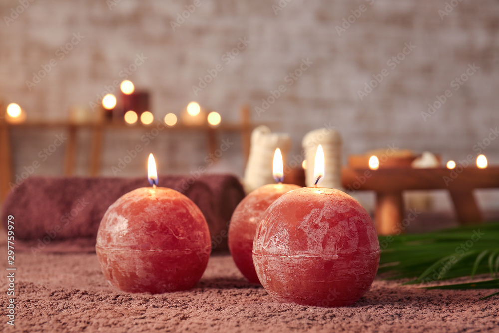 Beautiful burning candles in spa salon