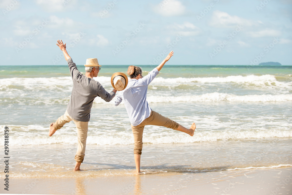 Happy asian senior couple  have fun and enjoy at the beach