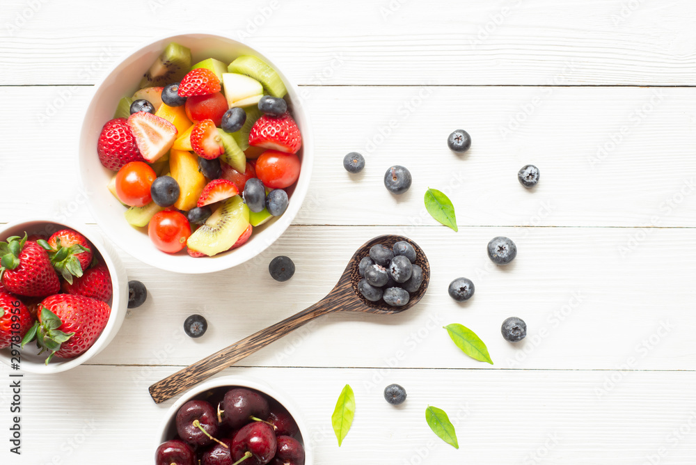 Healthy  food  concept  blueberries  kiwi strawberry tomato on white wood background