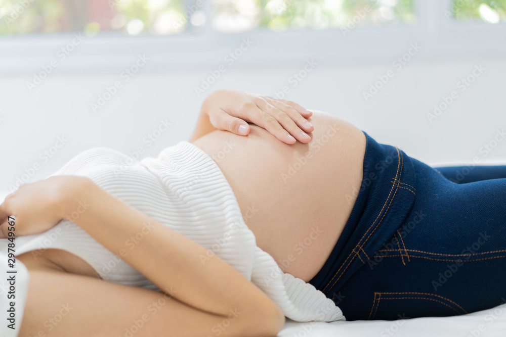 Pregnant happy woman touching belly