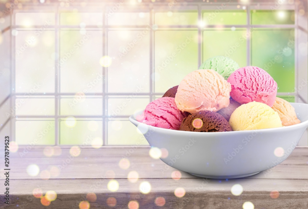 Ice cream scoops in bowl on white background