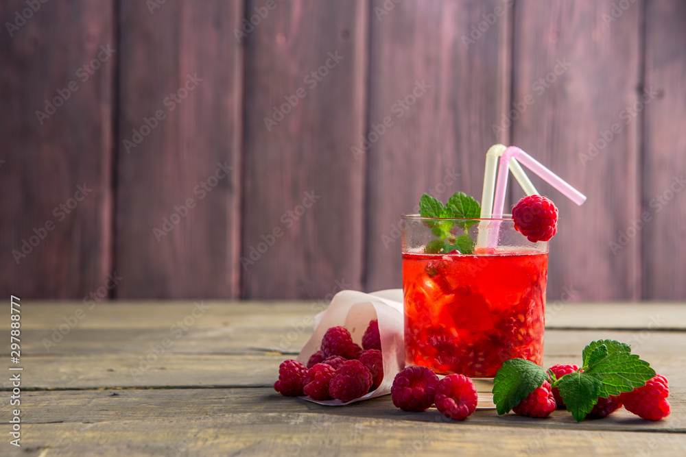 Glass of fresh strawberry summer cocktail and strawberries on the wooden background. Healthy food an