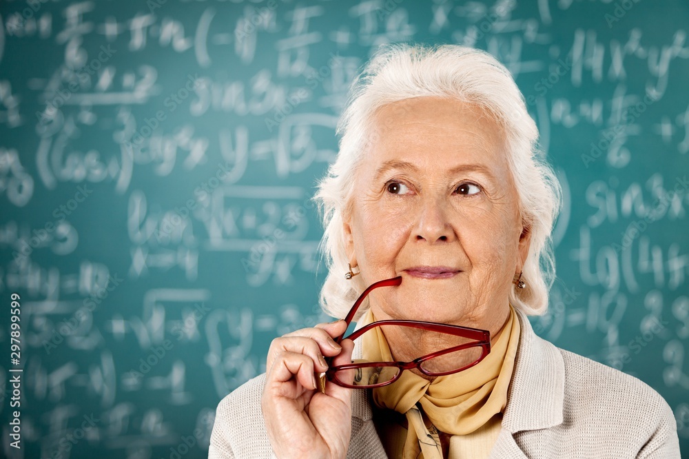 Mature woman teacher with books on background