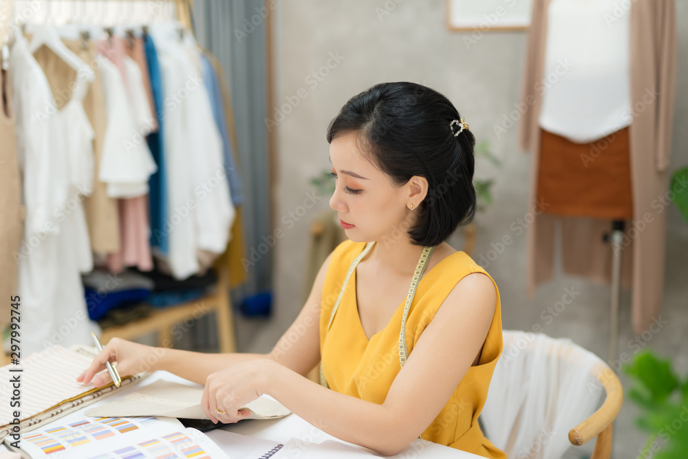 A young fashion designer working on her atelier