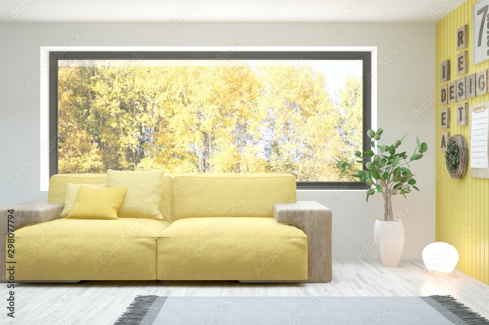 Stylish room in white color with sofa and autumn landscape in window. Scandinavian interior design. 