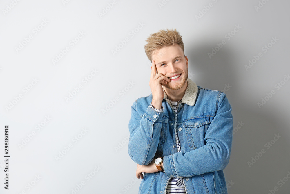 Portrait of stylish young man on light background