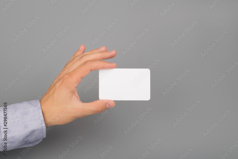 hand holds white business card