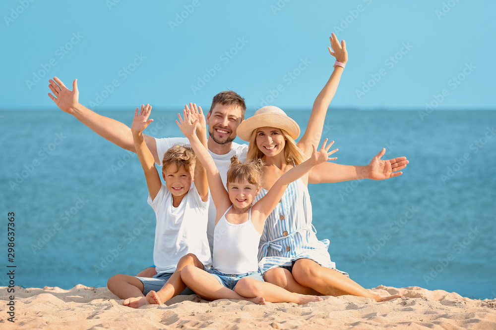 Portrait of happy family on sea beach