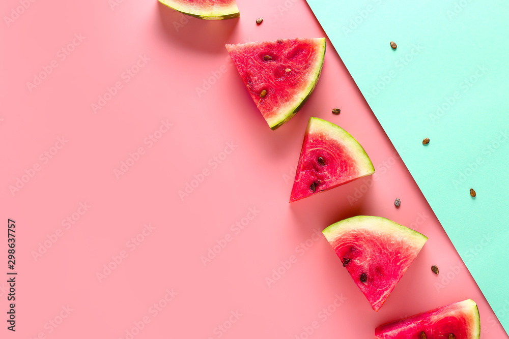 Slices of sweet ripe watermelon on color background